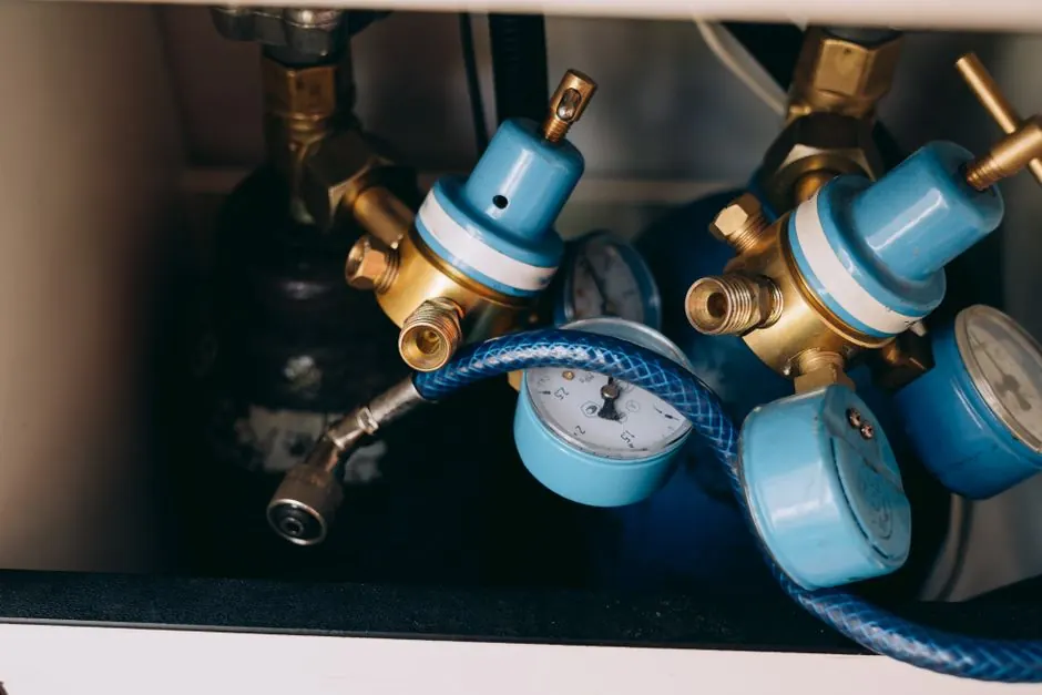 Brass shutoff valves and pressure regulators on a plumbing manifold