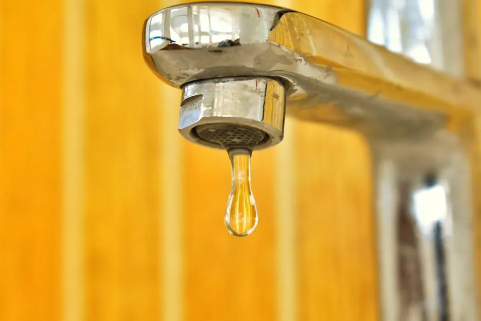 Water dripping from a chrome faucet